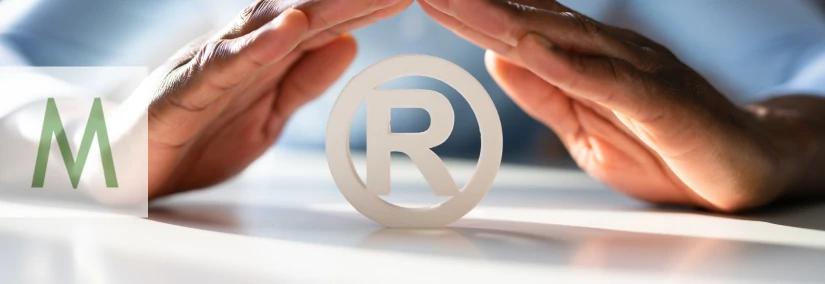 Hands protecting a registered trademark symbol